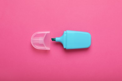 One marker with cap on pink background, top view