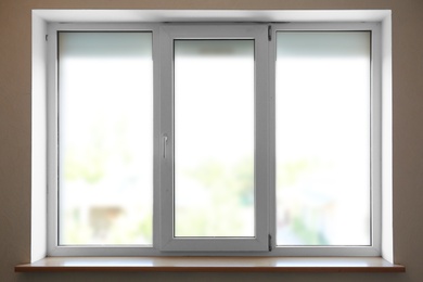 Photo of Modern plastic window with empty sill indoors