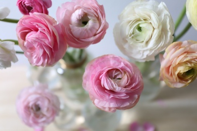 Photo of Beautiful fresh ranunculus flowers on table, closeup view