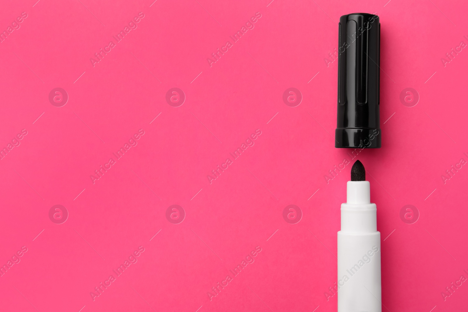 Photo of Black marker on pink background, flat lay. Space for text