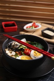 Photo of Delicious vegetarian ramen served on table, closeup. Noodle soup