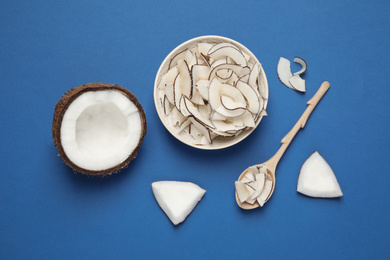 Photo of Flat lay composition with tasty coconut chips on blue background