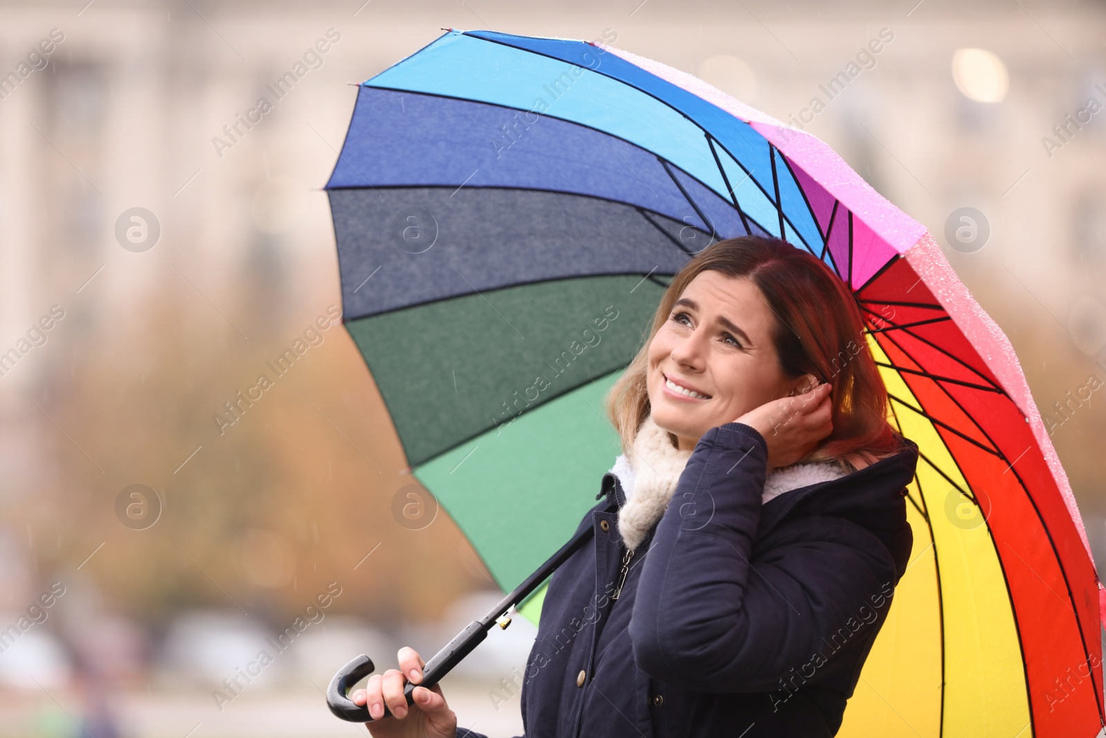 Photo of Woman with umbrella in city on autumn rainy day