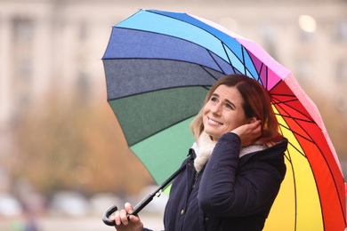 Photo of Woman with umbrella in city on autumn rainy day