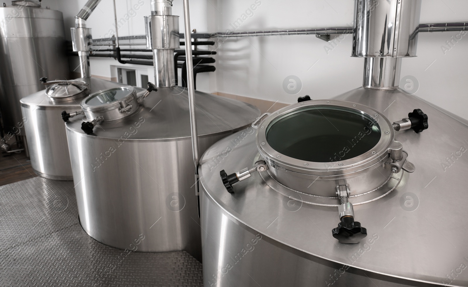 Photo of Steel tanks for beer fermentation in brewhouse