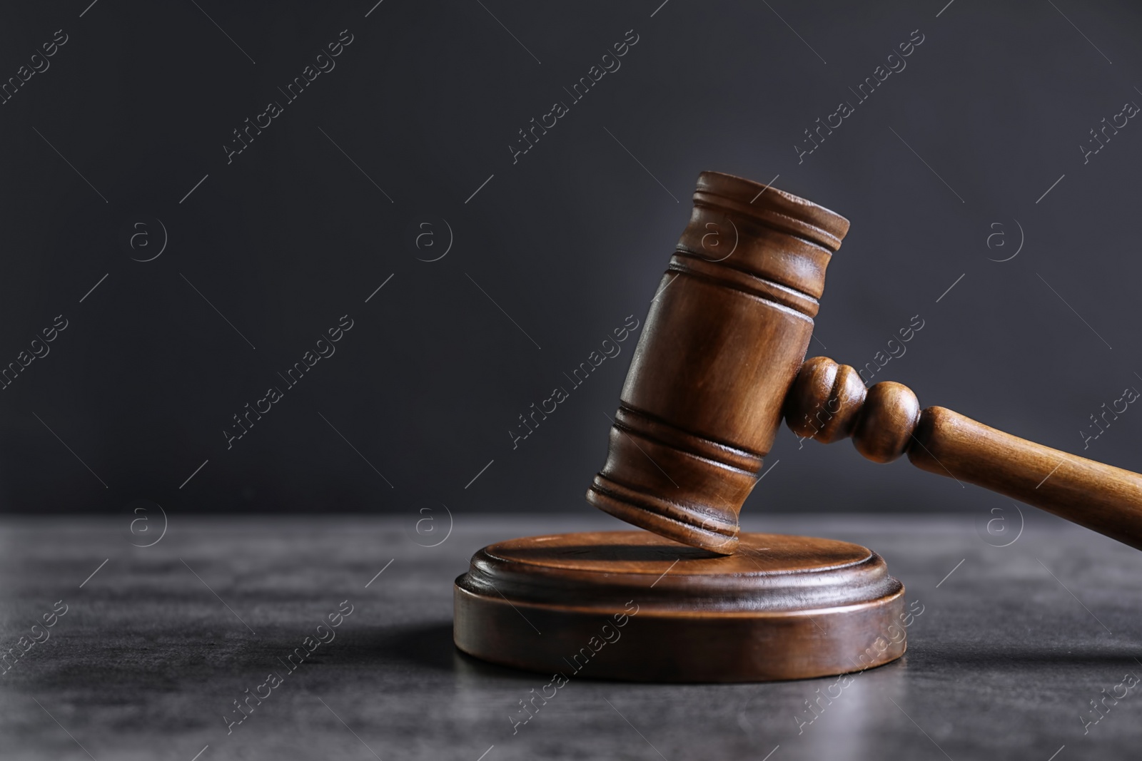 Photo of Judge's gavel on grey table. Law concept