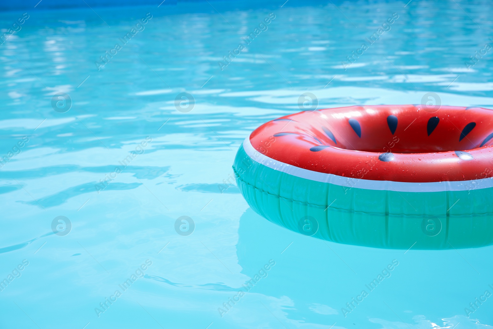 Photo of Inflatable ring in swimming pool on sunny day. Space for text