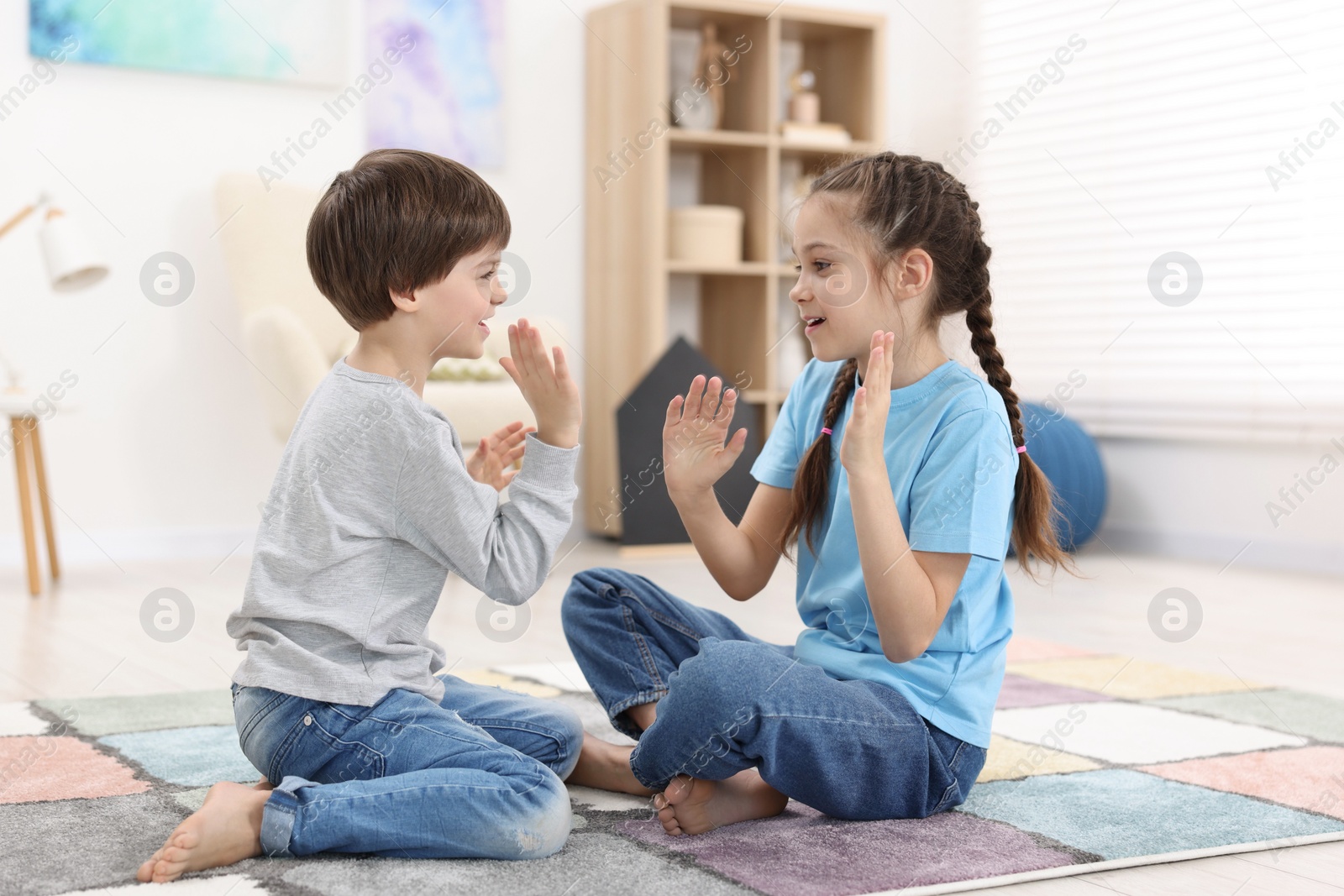 Photo of Happy brother and sister spending time together at home