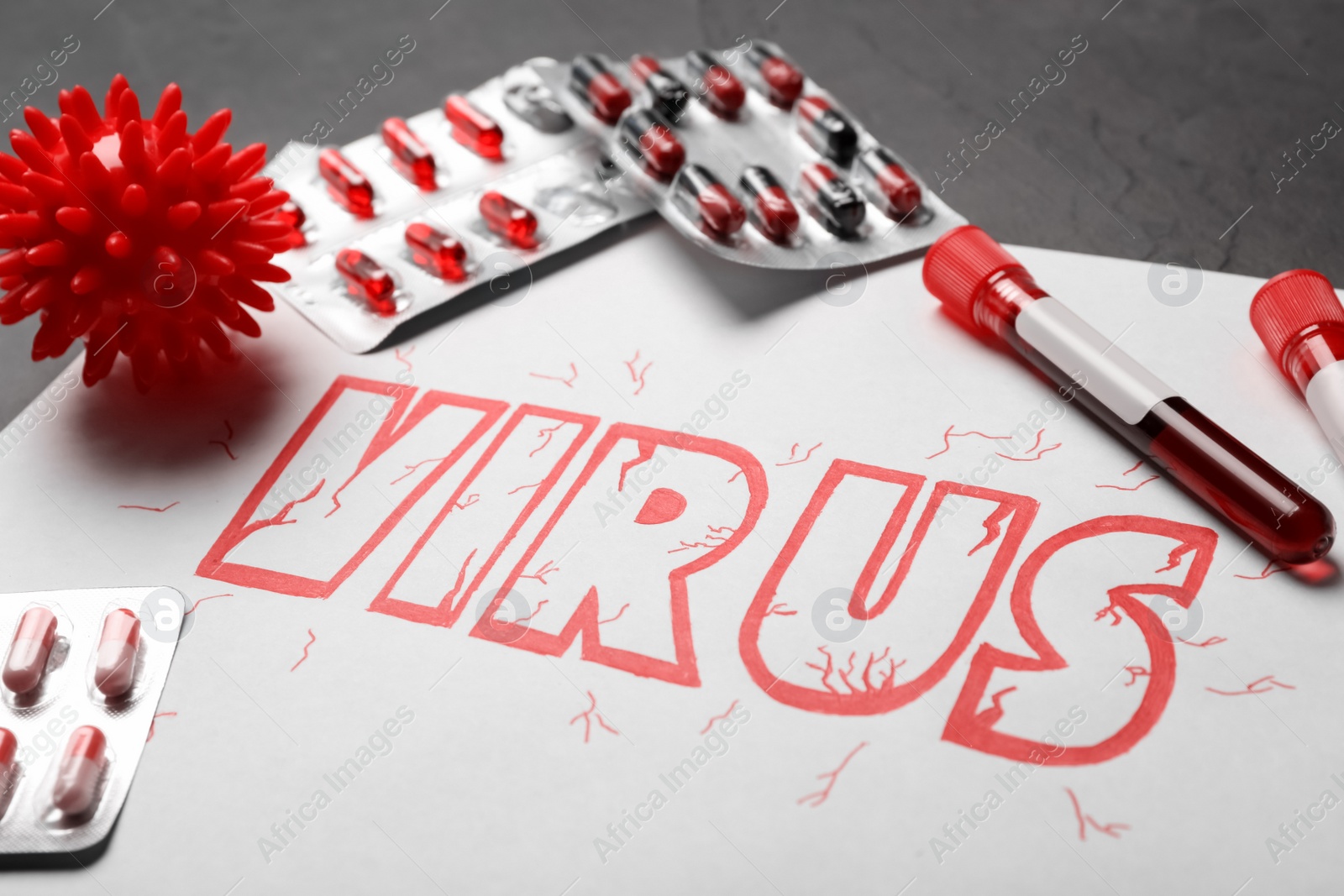 Photo of Paper with word VIRUS and medicines, closeup
