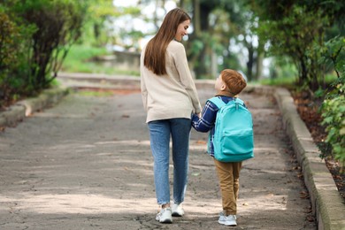 Photo of Young mom taking her son to school
