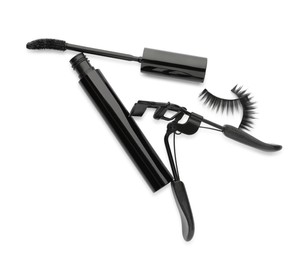 False eyelashes, curler and mascara on white background, top view