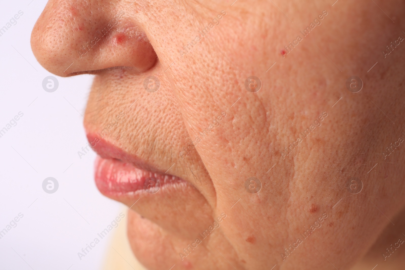 Photo of Closeup view of older woman on white background