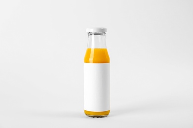 Photo of Bottle with delicious fresh juice on white background