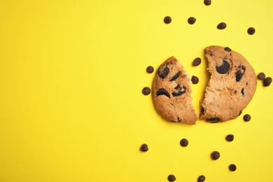 Photo of Delicious chocolate chip cookie on color background, top view. Space for text