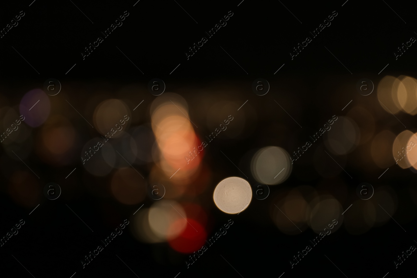 Photo of Blurred view of colorful glowing lights outdoors, bokeh effect