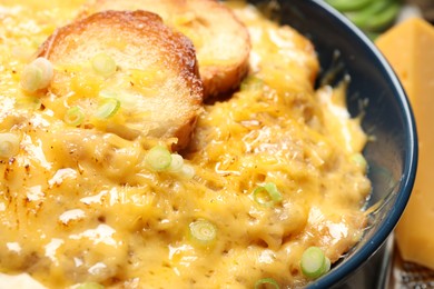 Photo of Tasty homemade French onion soup in bowl, closeup