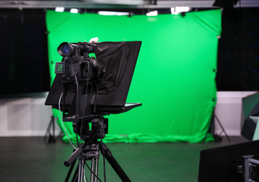 Photo of Modern video recording studio with professional equipment, focus on camera