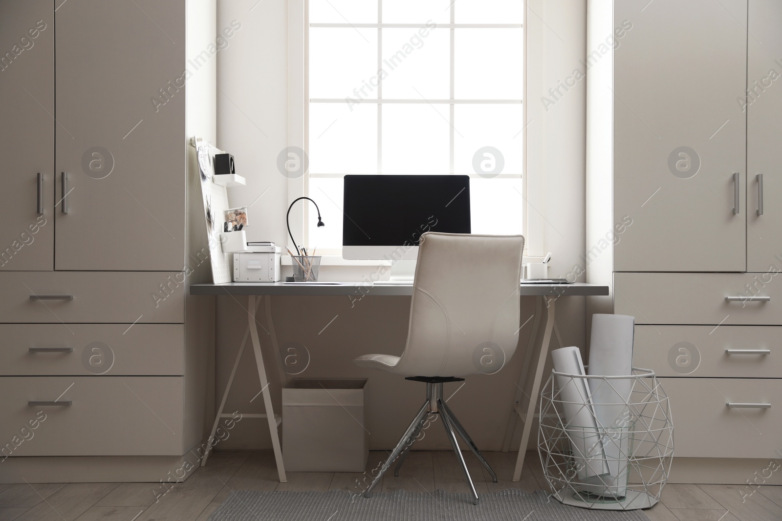 Photo of Light work place with computer near window. Interior design