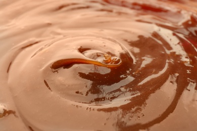 Photo of Delicious sweet caramel sauce as background, closeup