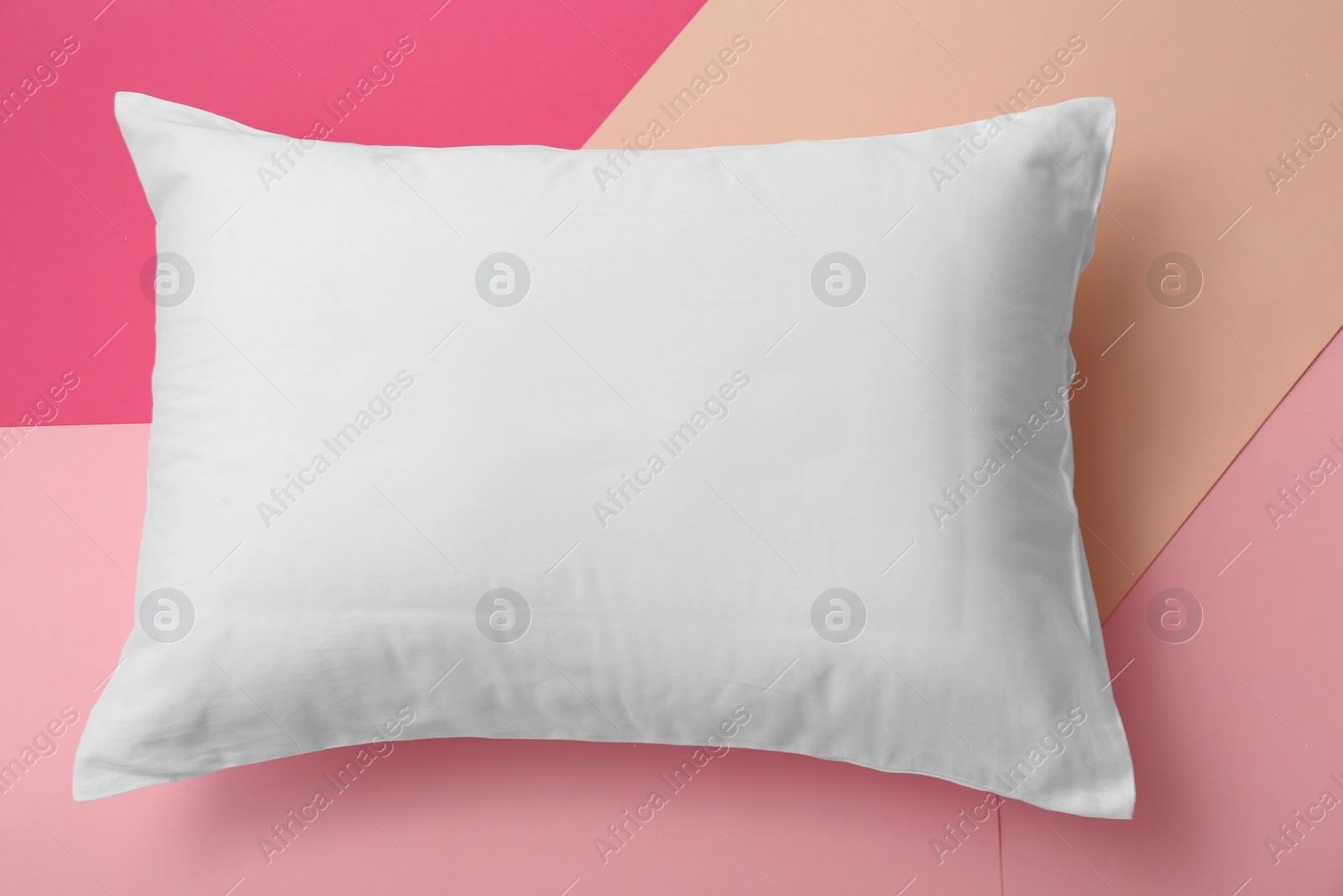 Photo of Soft bed pillow on color background, top view