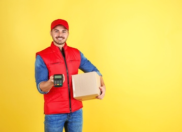 Photo of Male courier with parcel and payment terminal on color background. Space for text