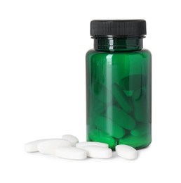 Photo of Bottle and pile of vitamin pills isolated on white