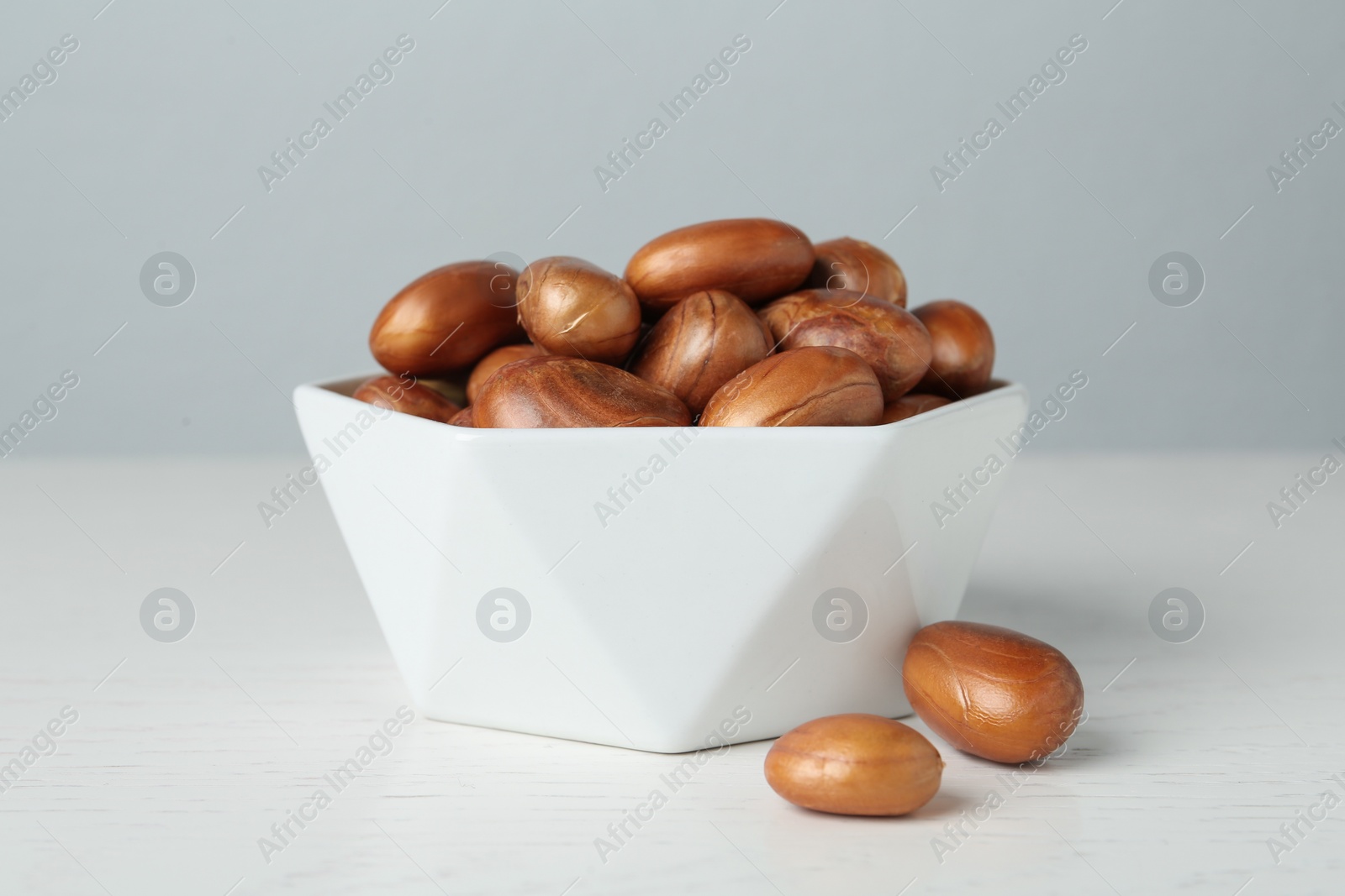 Photo of Bowl of jackfruit seeds on white wooden table