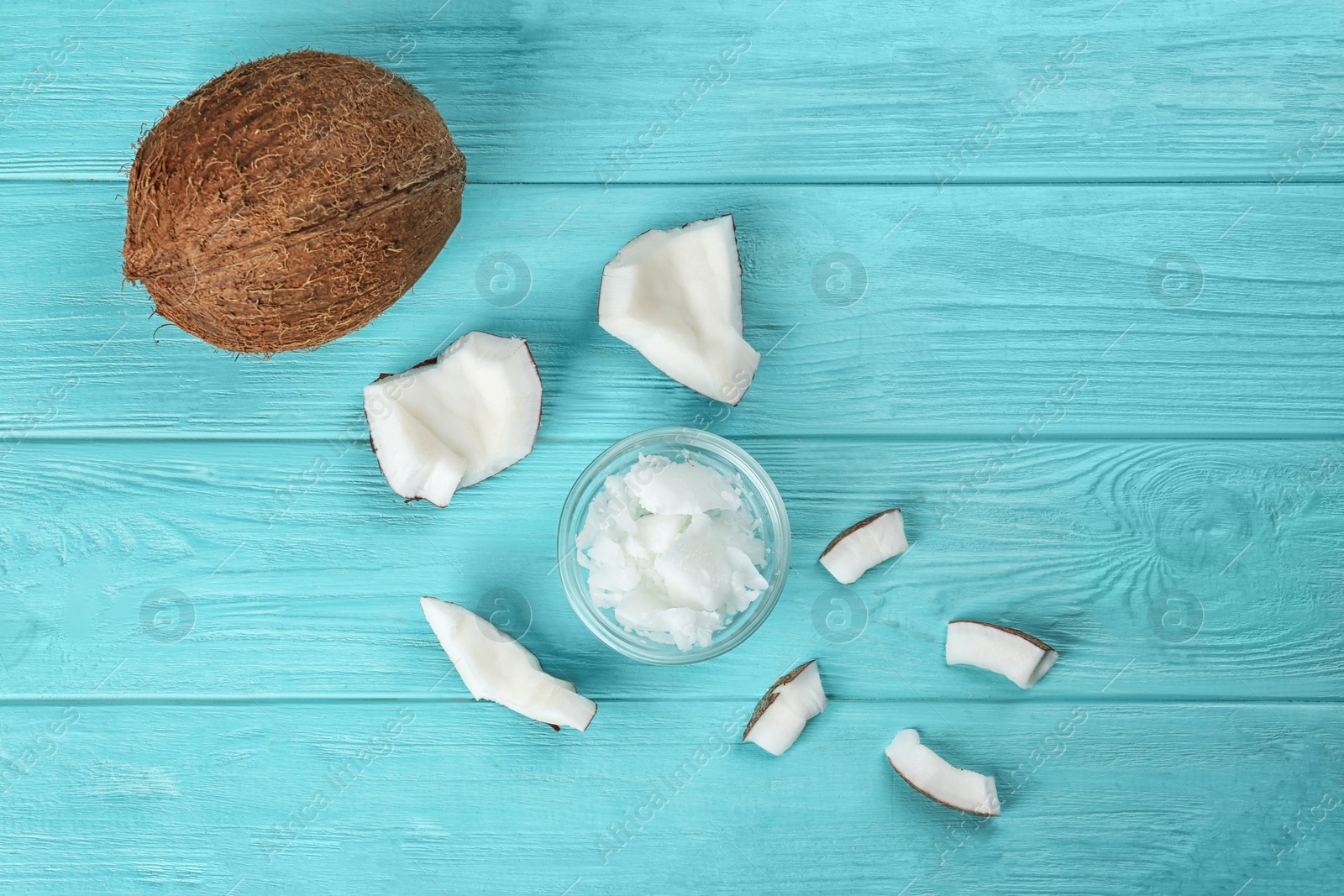 Photo of Flat lay composition with organic coconut oil on light blue wooden table. Healthy cooking