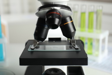 Photo of Modern microscope with different lenses in laboratory, closeup. Medical equipment