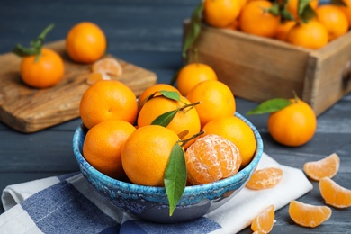 Fresh ripe tangerines in bowl on table