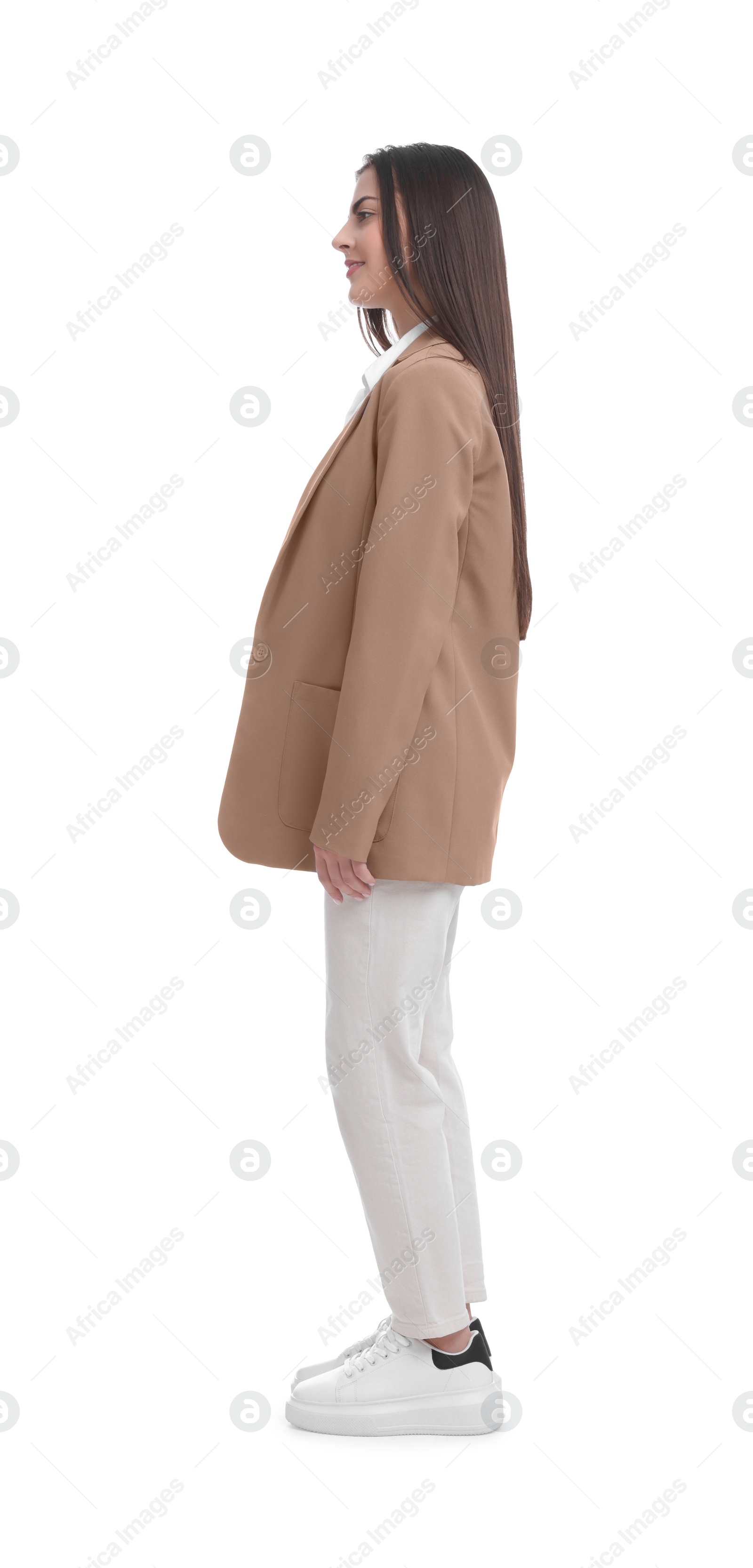 Photo of Young businesswoman in suit standing on white background