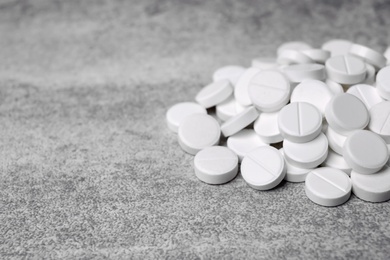 Photo of White pills on grey background