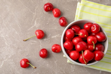 Bowl with sweet red cherries on table