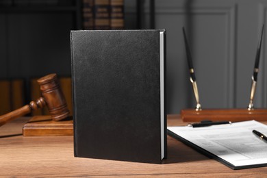 Tax law. Book, form and gavel on wooden table