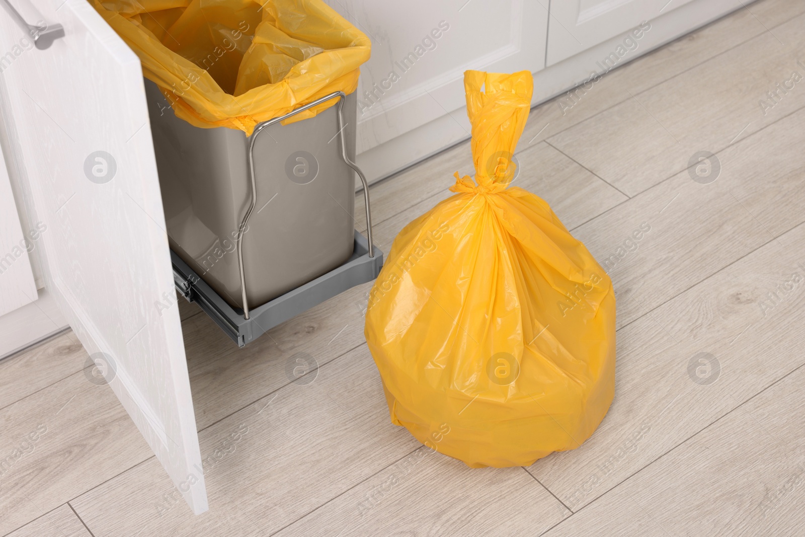 Photo of Plastic garbage bag and trash can indoors