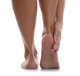 Photo of Back view of woman suffering from foot pain on white background, closeup