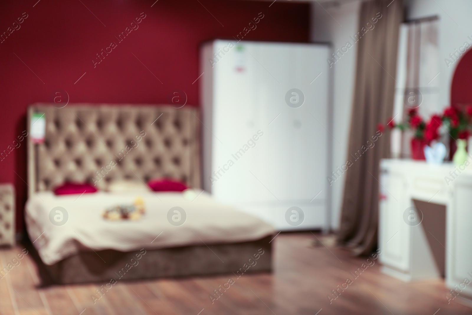 Photo of Blurred view of bedroom interior with stylish furniture