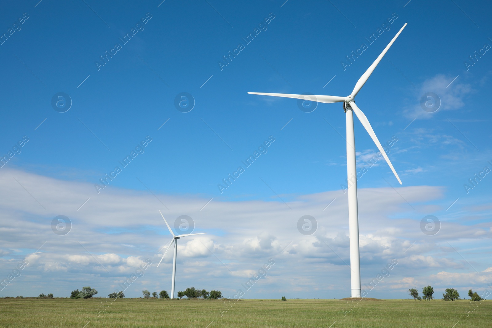 Photo of Beautiful view of field with wind turbines. Alternative energy source