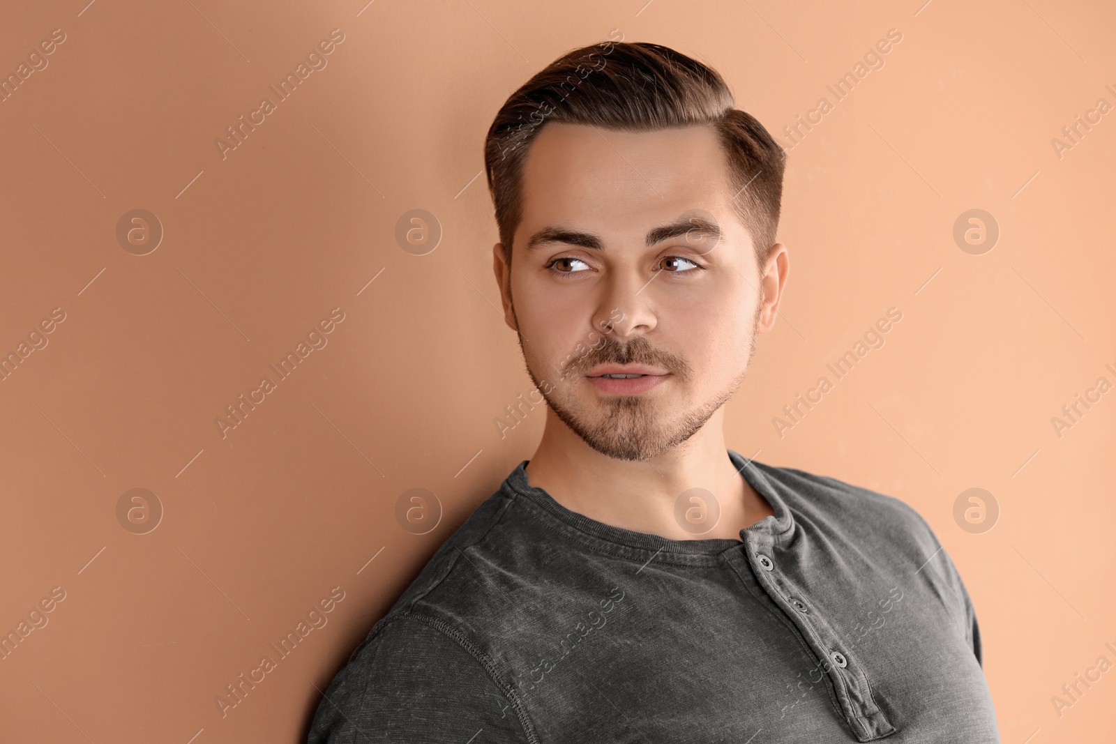 Photo of Portrait of young man with beautiful hair on color background