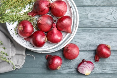 Photo of Flat lay composition with ripe red onions on wooden table