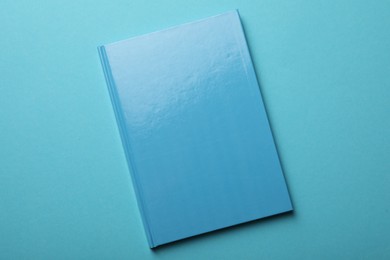 Photo of New bright planner on light blue background, top view
