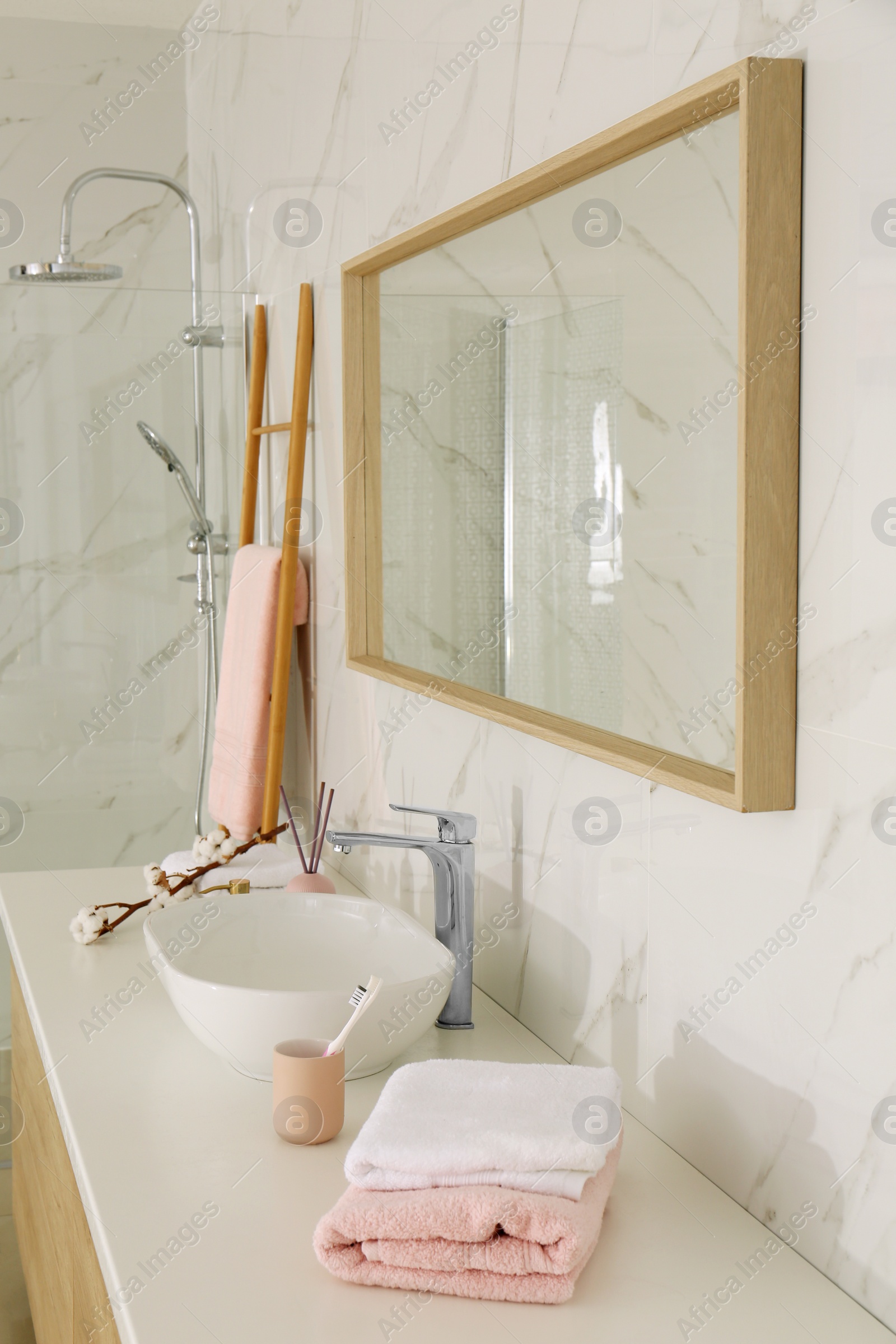 Photo of Large mirror over vessel sink in stylish bathroom interior