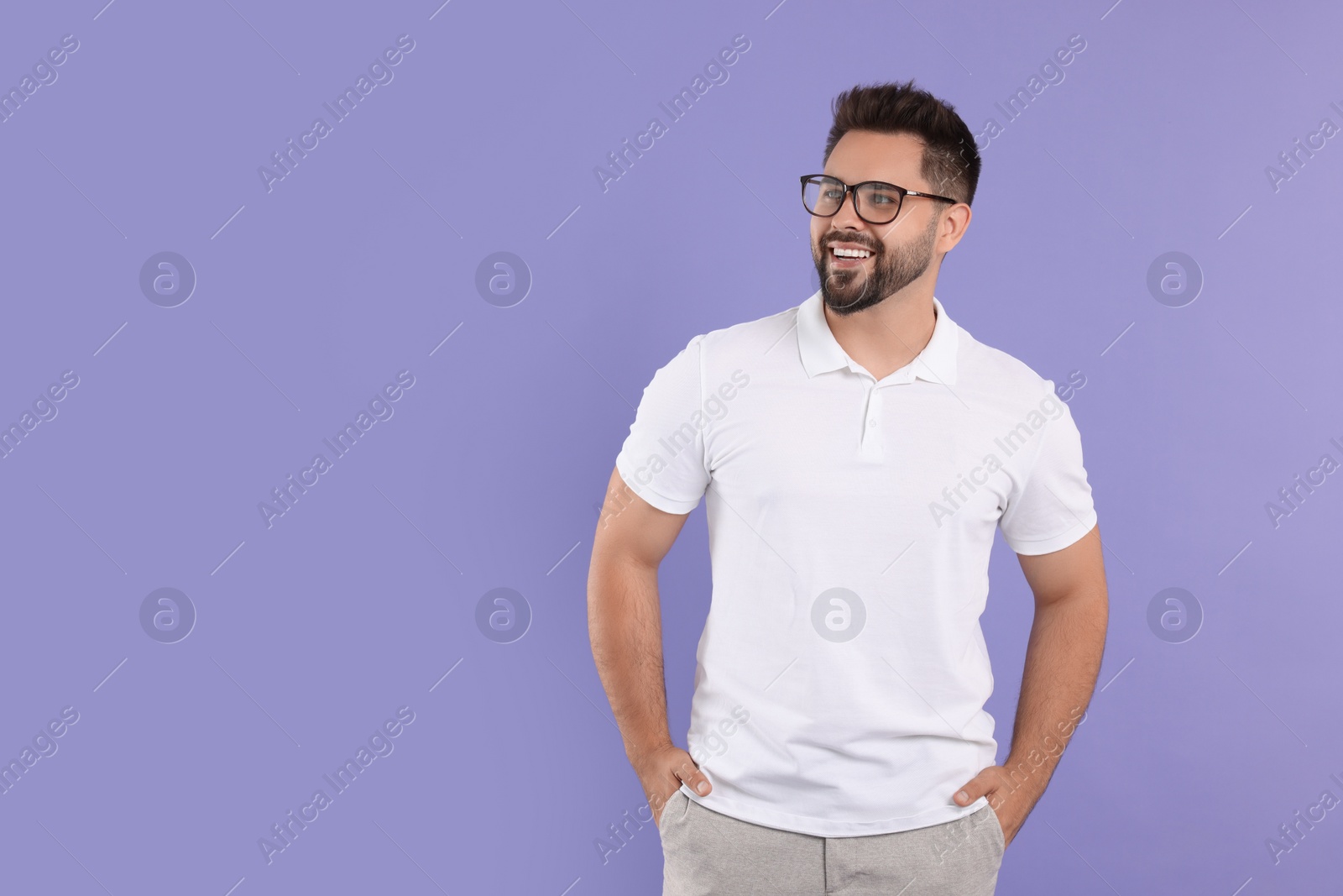 Photo of Handsome man wearing glasses on violet background, space for text