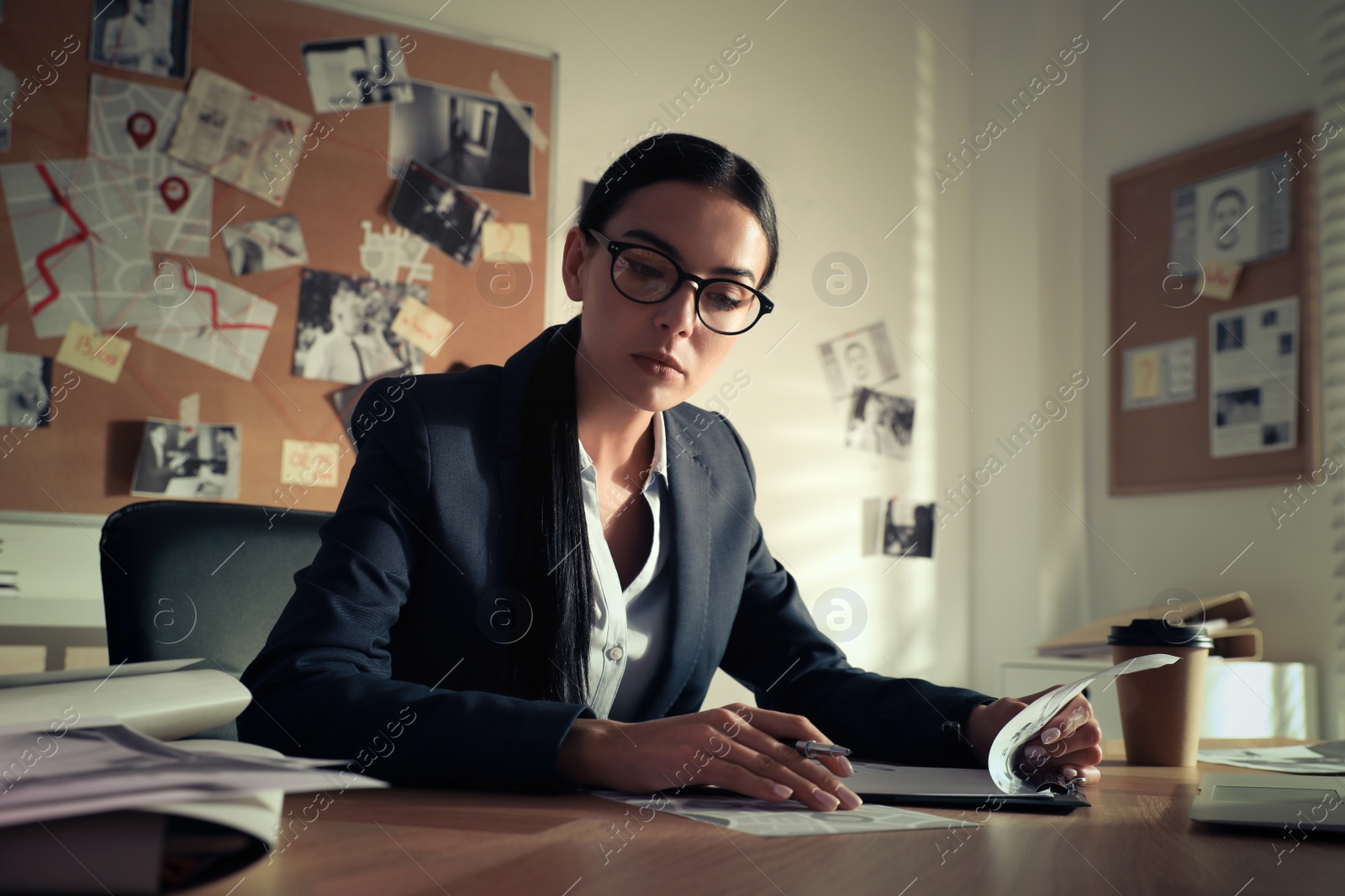 Photo of Detective working at desk in her office