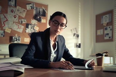 Detective working at desk in her office