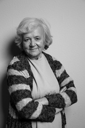 Photo of Portrait of elderly woman on grey background. Black and white effect