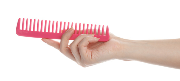 Woman holding hair comb on white background, closeup