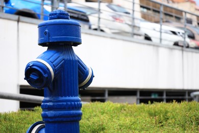 Blue metal fire hydrant on city street, closeup. Space for text