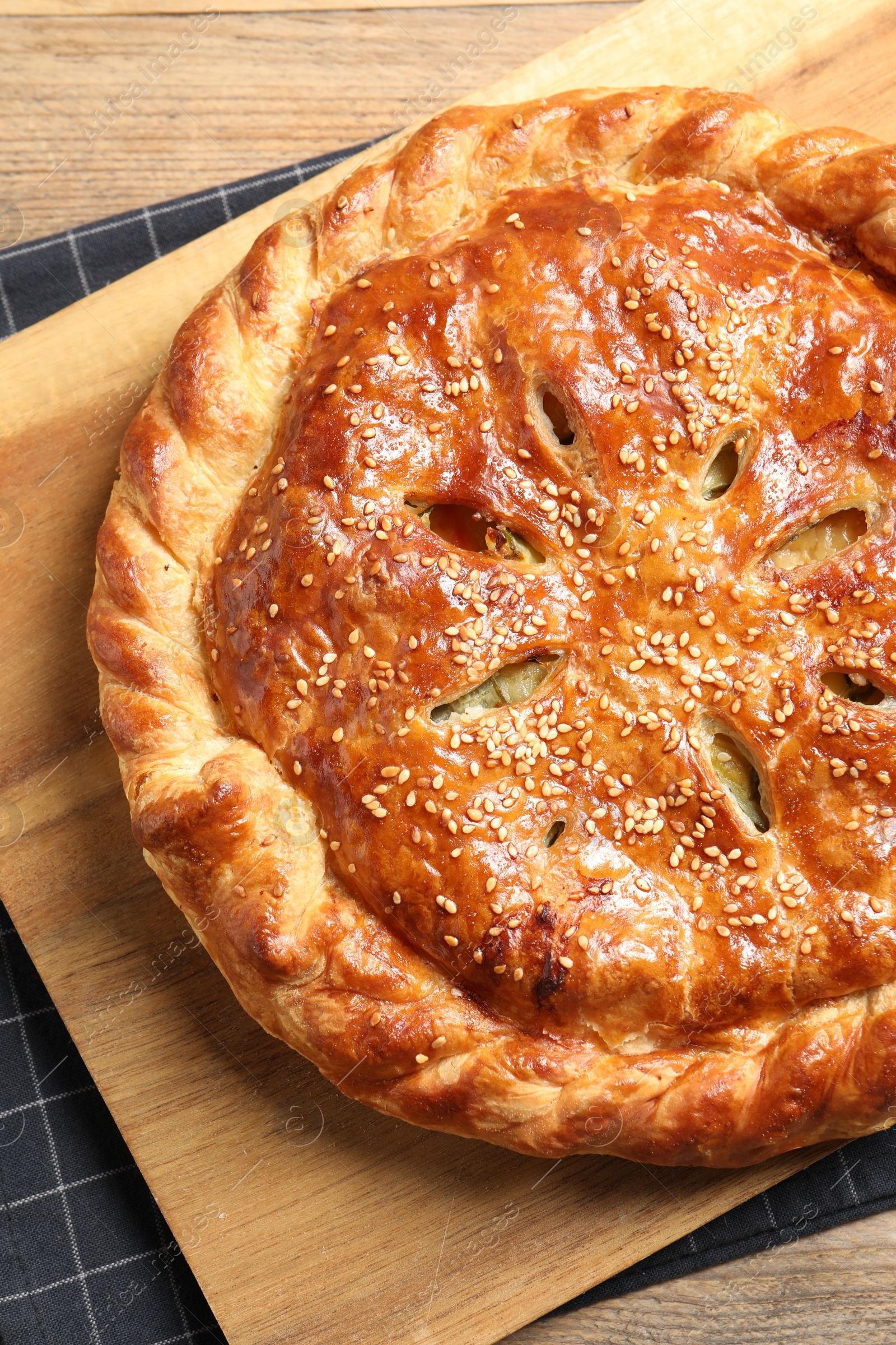 Photo of Tasty homemade pie with filling on wooden table, top view