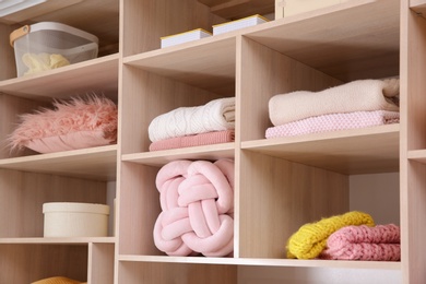 Photo of Wardrobe with stylish clothes and home stuff, closeup